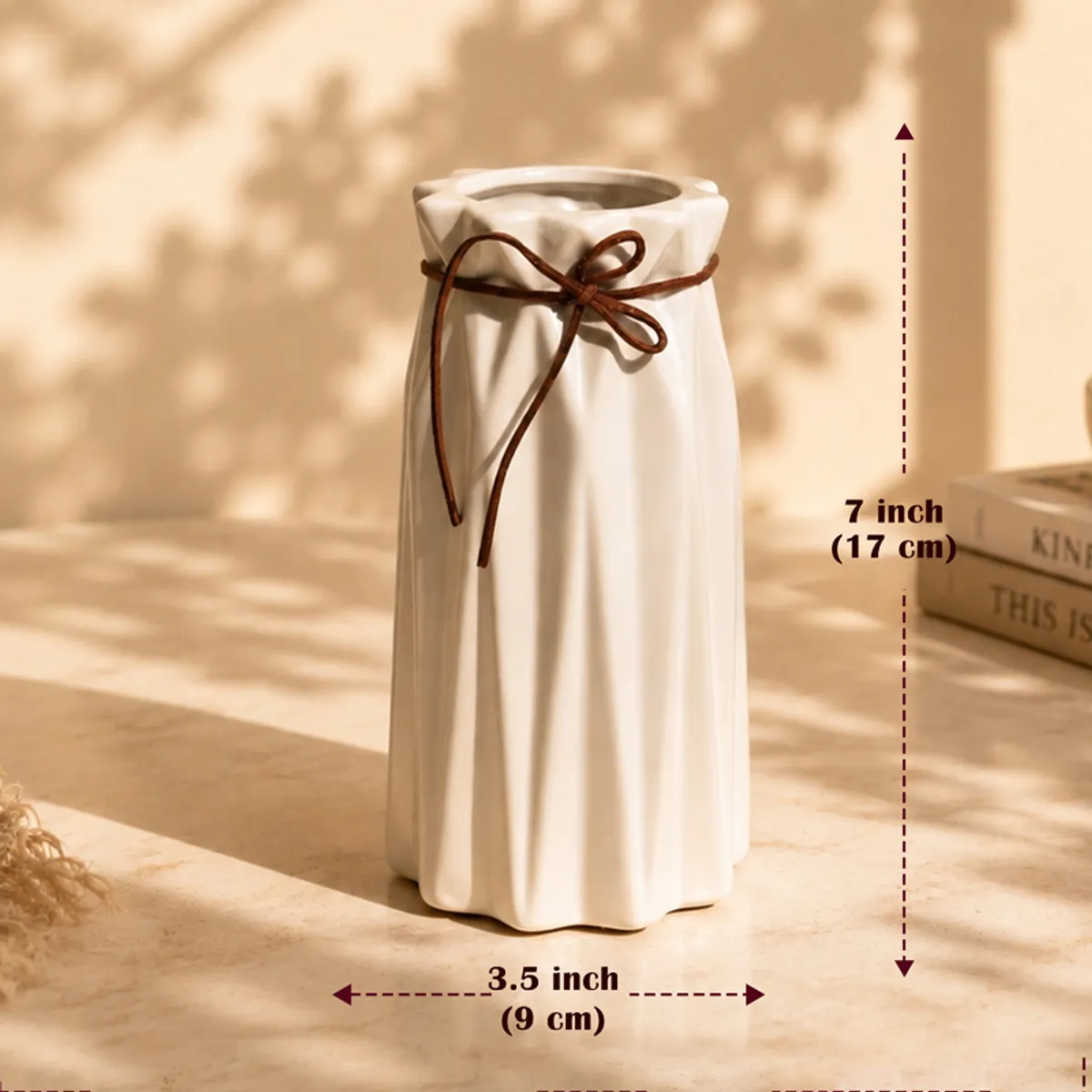 White pleated vase with a brown bow shown with dimension arrows