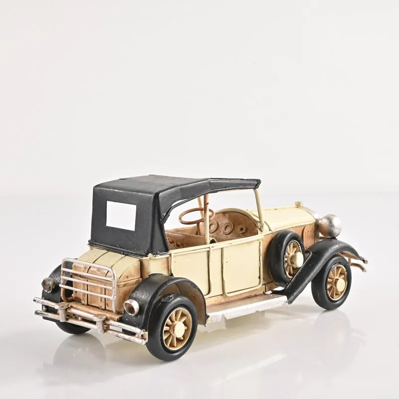 Rear three-quarter view of the beige vintage model car showpiece