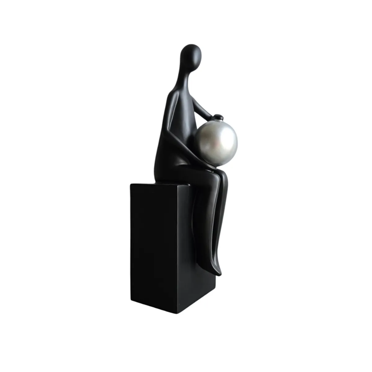 Side view of a black seated figurine holding a silver sphere