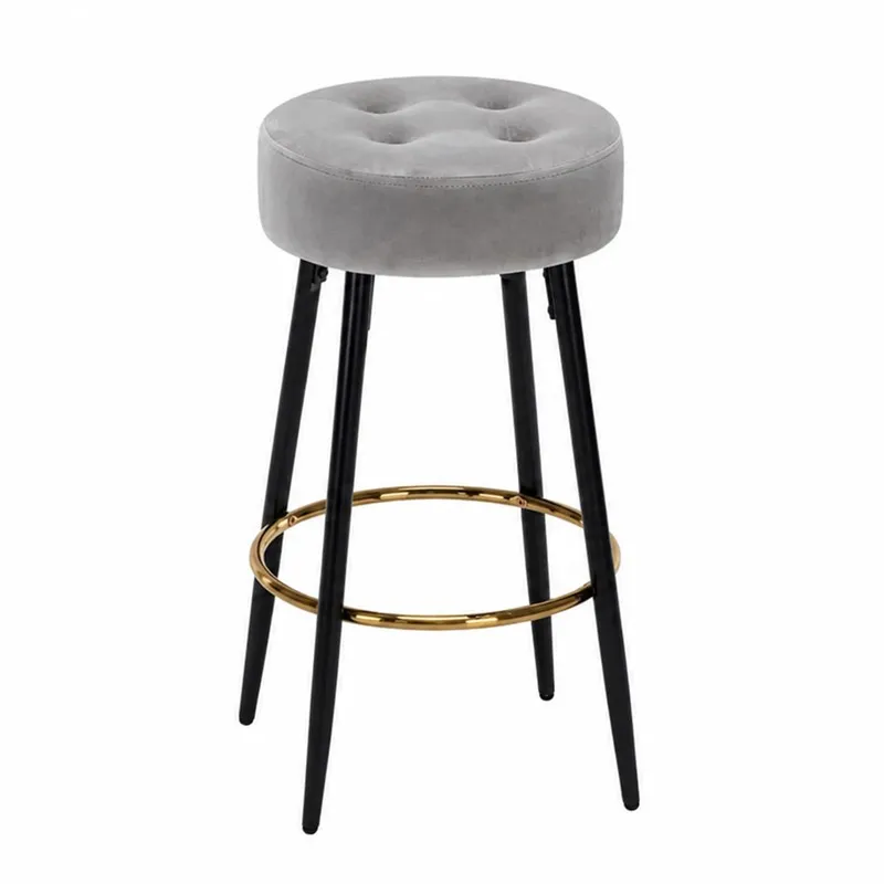 Grey round upholstered bar stool with black legs and gold ring footrest