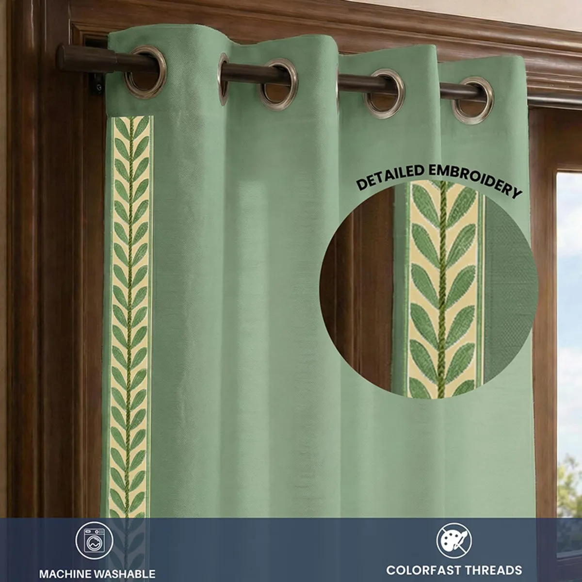 Close-up of green curtain with decorative leafy border and eyelets