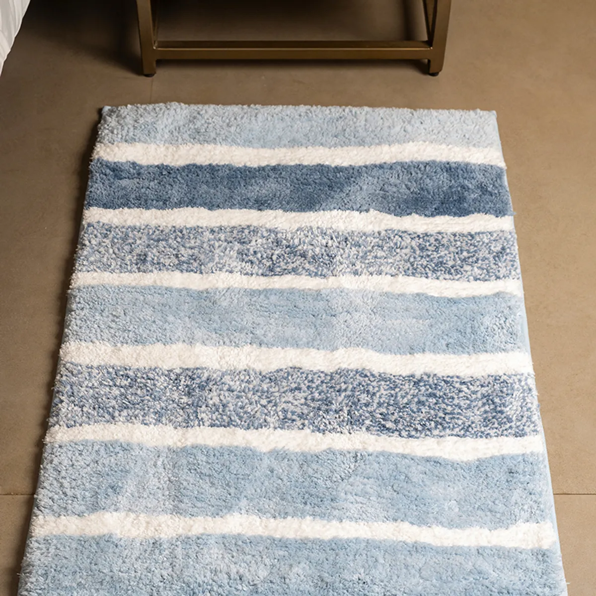 Close-up view of the blue and white striped plush runner