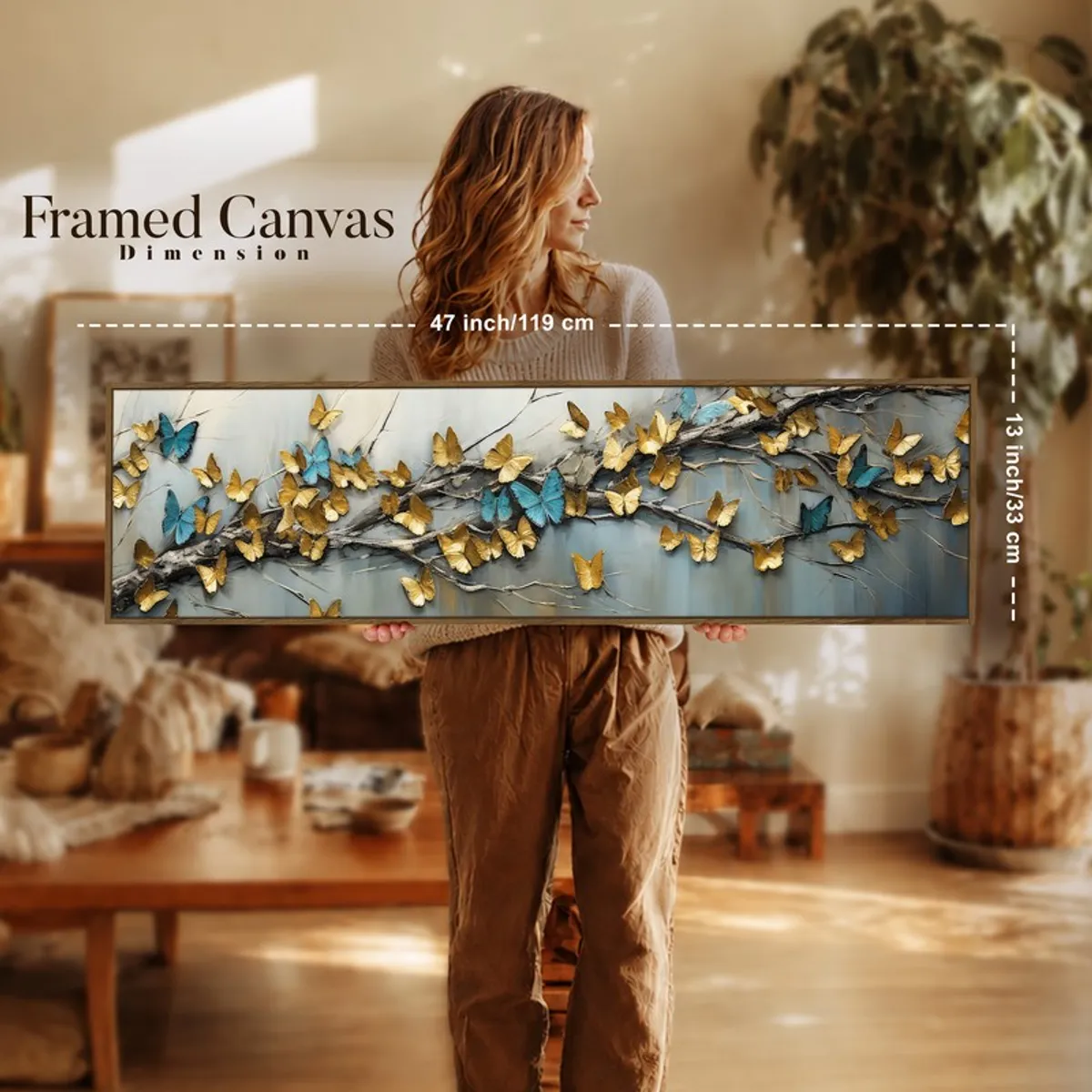 Woman holding a long framed butterfly canvas art indoors