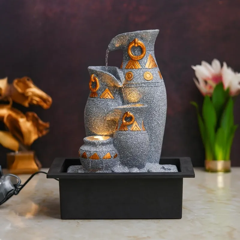 Front view of the grey and gold pitcher-style LED fountain with flowing water.