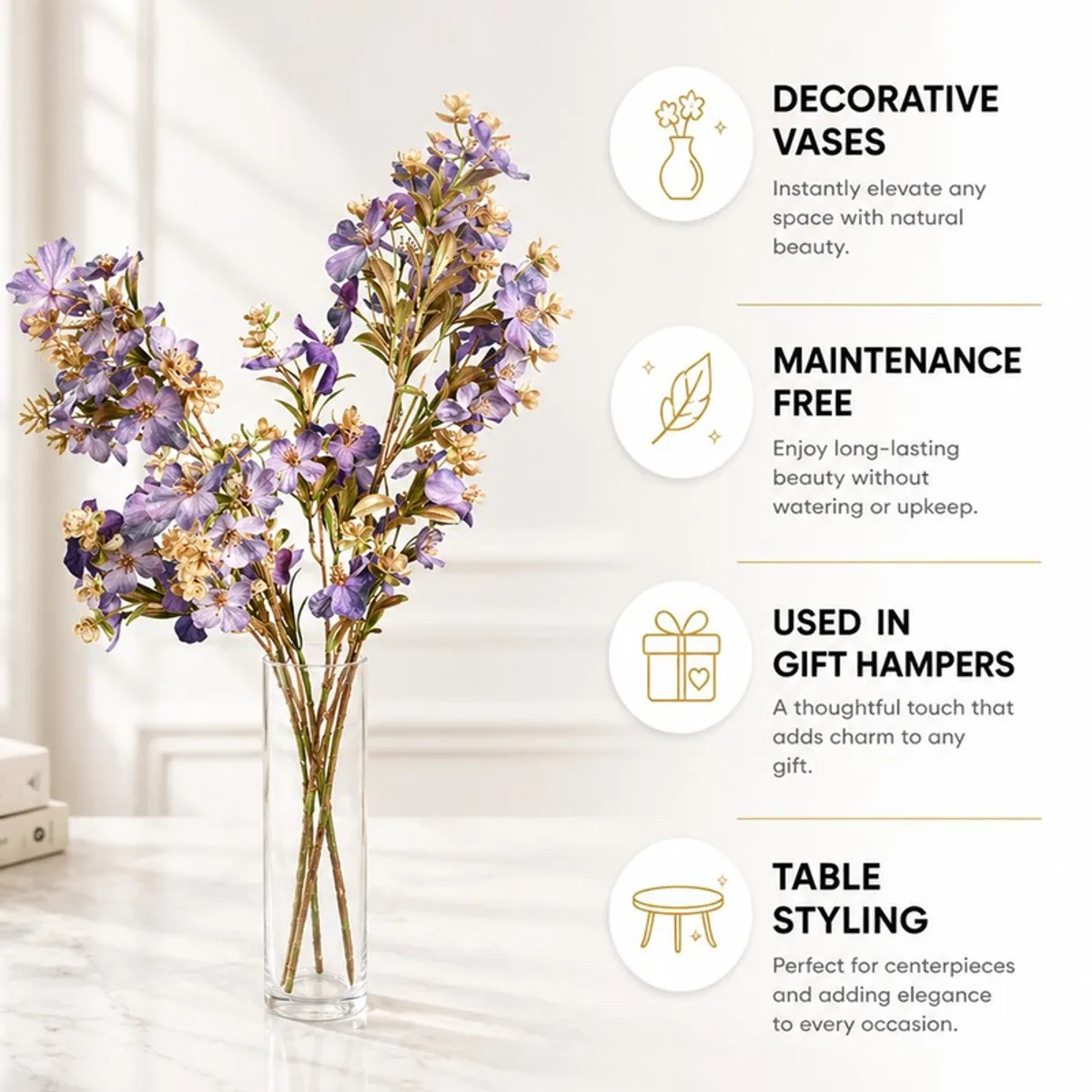 Purple and gold artificial flower stems displayed in a clear vase on a table