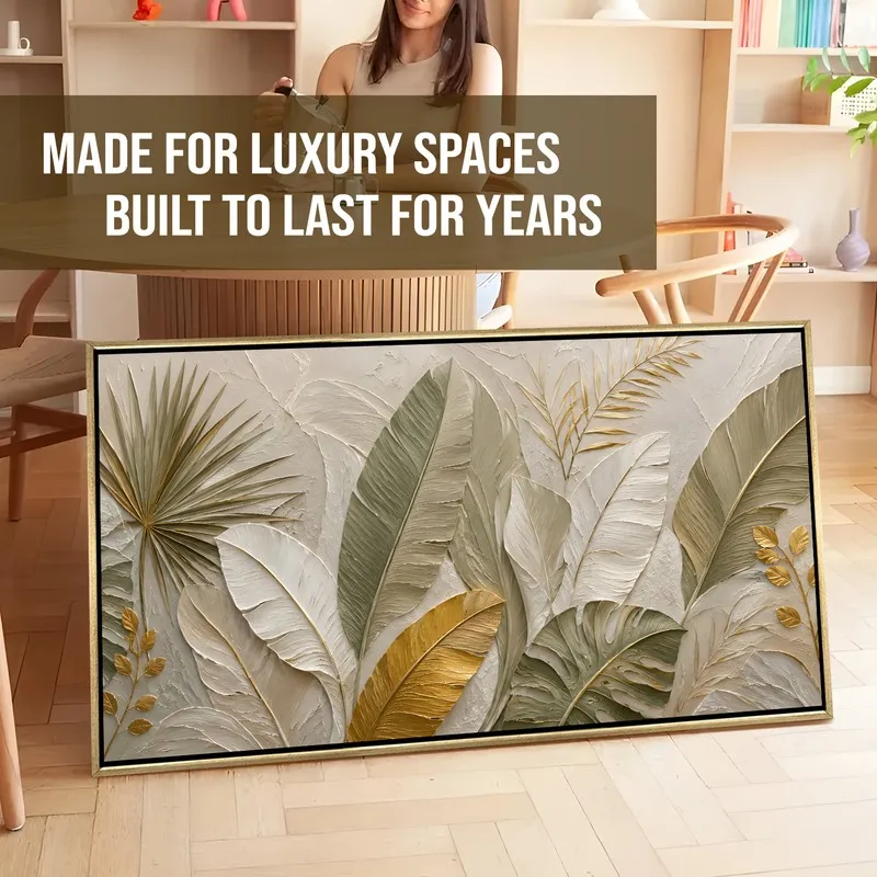Large tropical leaves framed canvas artwork leaning against a wall indoors