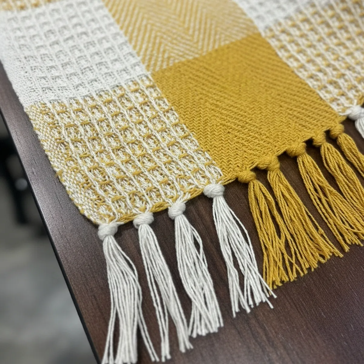 Close-up of yellow and white throw texture with fringed edge