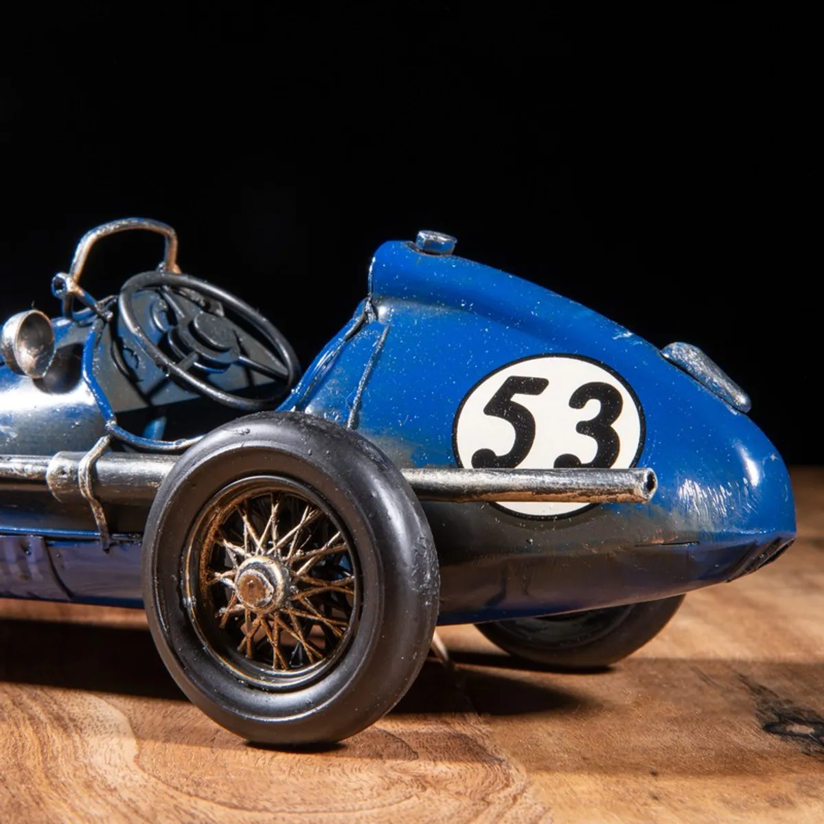 Close-up of rear side of blue racing car showpiece