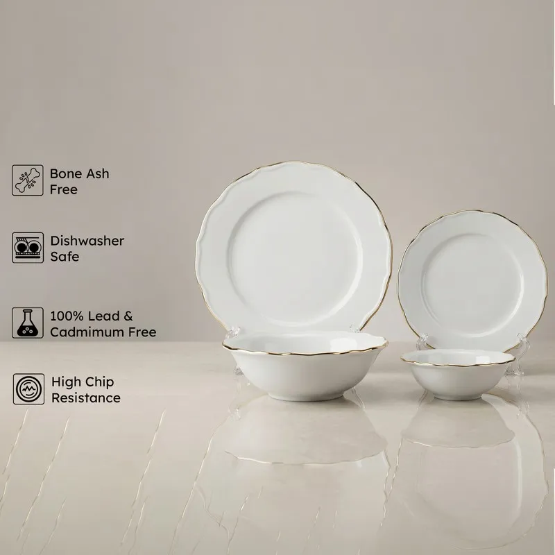 White porcelain plates and bowls with gold rims displayed upright