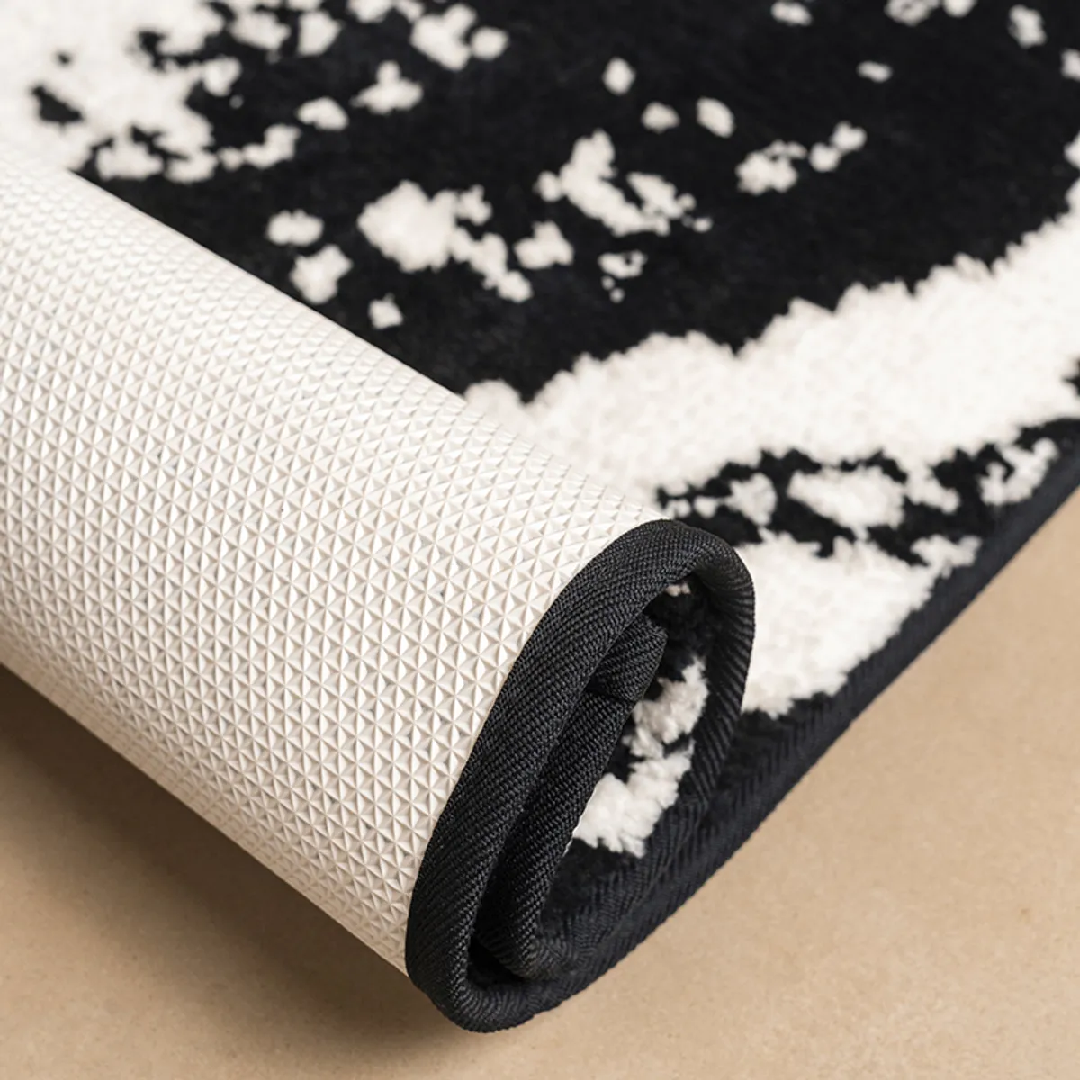 Close-up of the rug's textured surface and patterned underside with anti-skid backing.