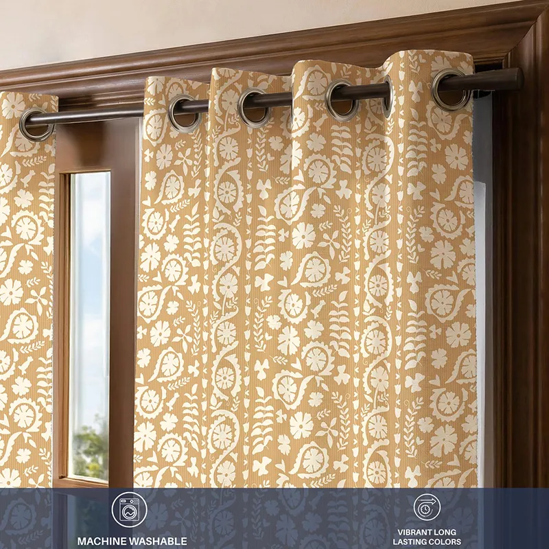 Close-up of beige floral curtain with eyelets and printed pattern