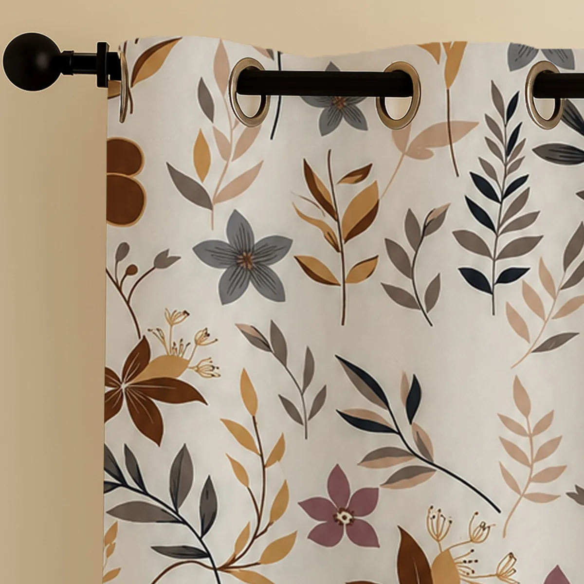 Close-up of the floral curtain fabric and metal eyelets on a curtain rod.