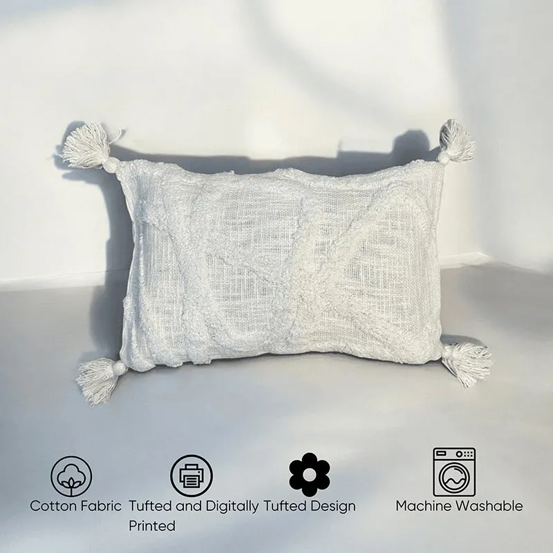 Single grey tufted rectangular cushion cover with tassels on a light floor