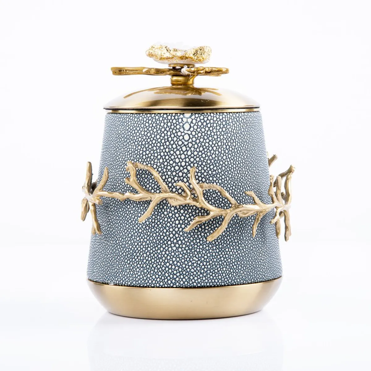 Front view of a blue textured showpiece with gold accents and lid