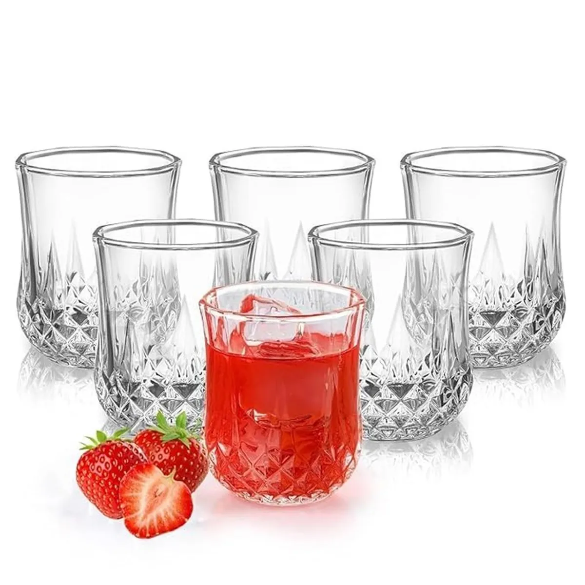 Six clear textured glasses, including one filled with a red drink and strawberries