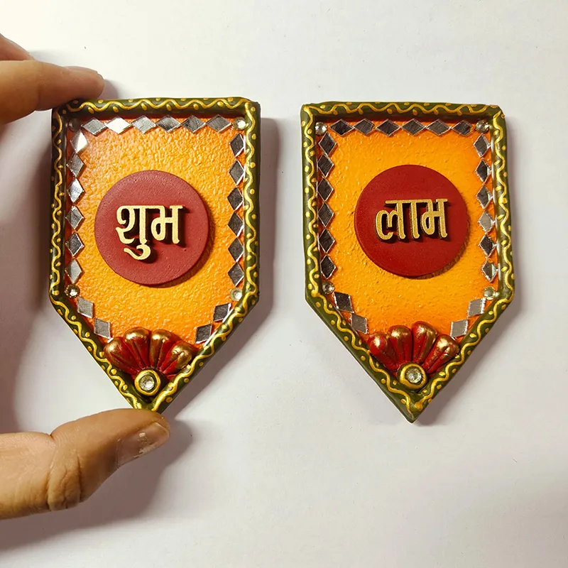Shubh Labh wall accents shown in hand for scale