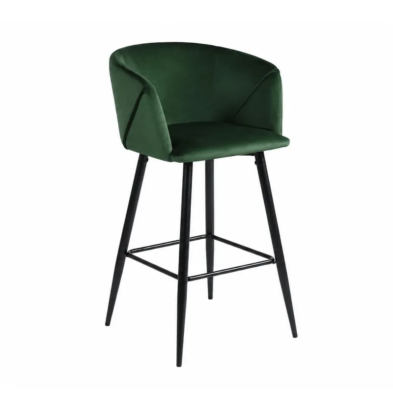 Angled view of green velvet bar chair with curved back and black legs