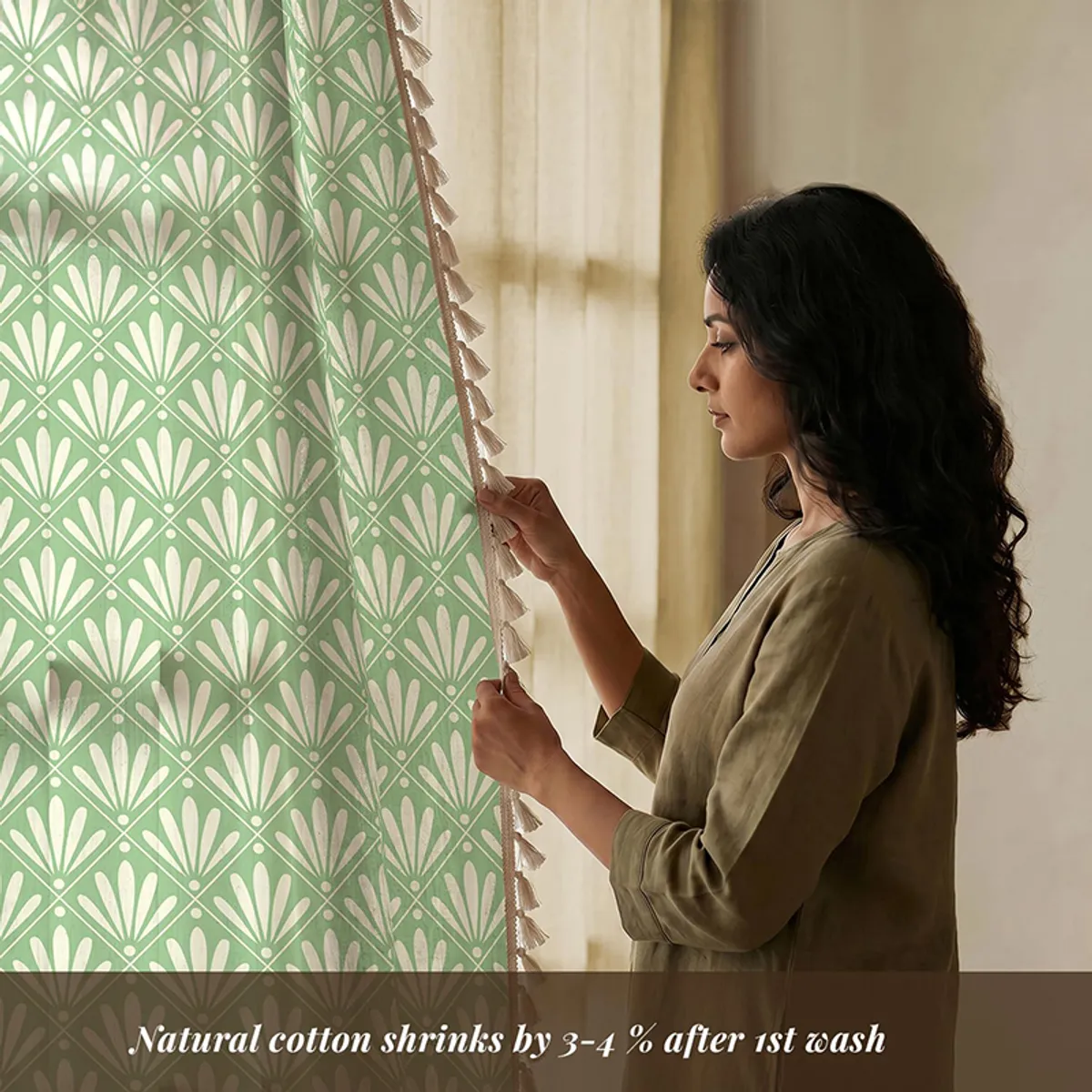 Close view of sage patterned cotton curtain with tasselled edge
