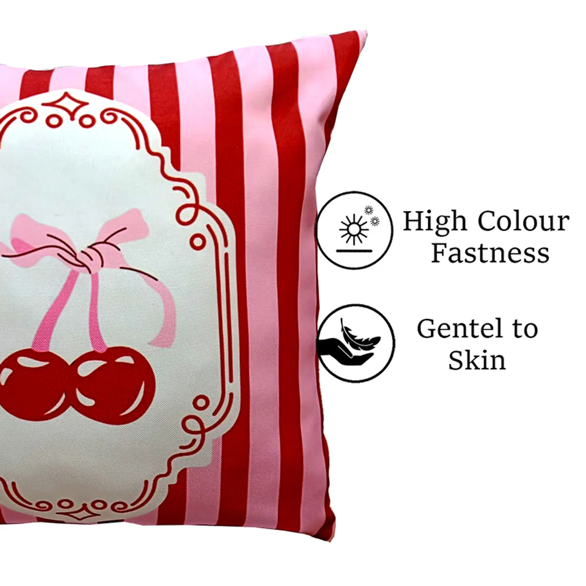 Close-up of a pink and red striped cushion cover with cherry print