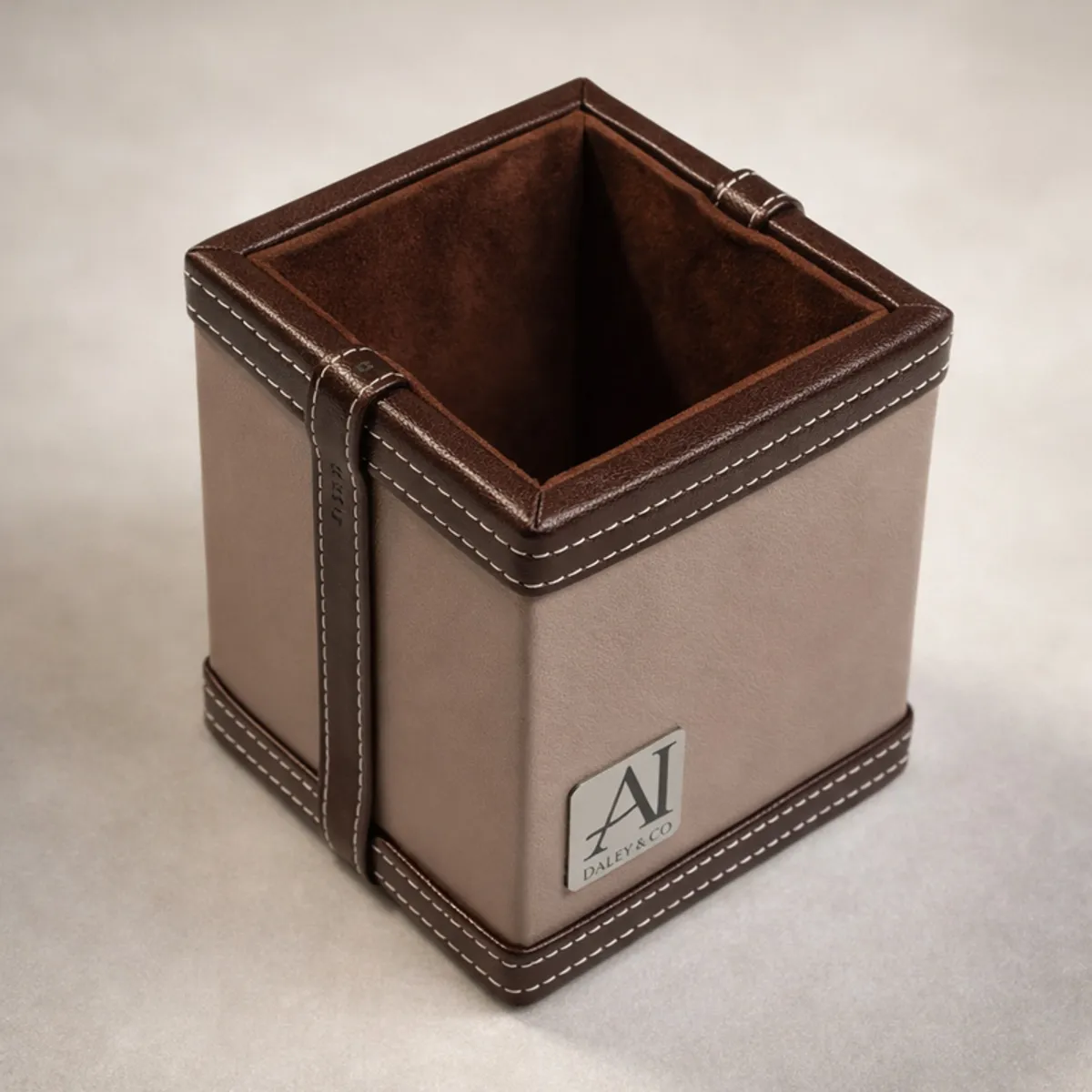 Empty square grey and brown vegan leather pen stand showing its storage compartment