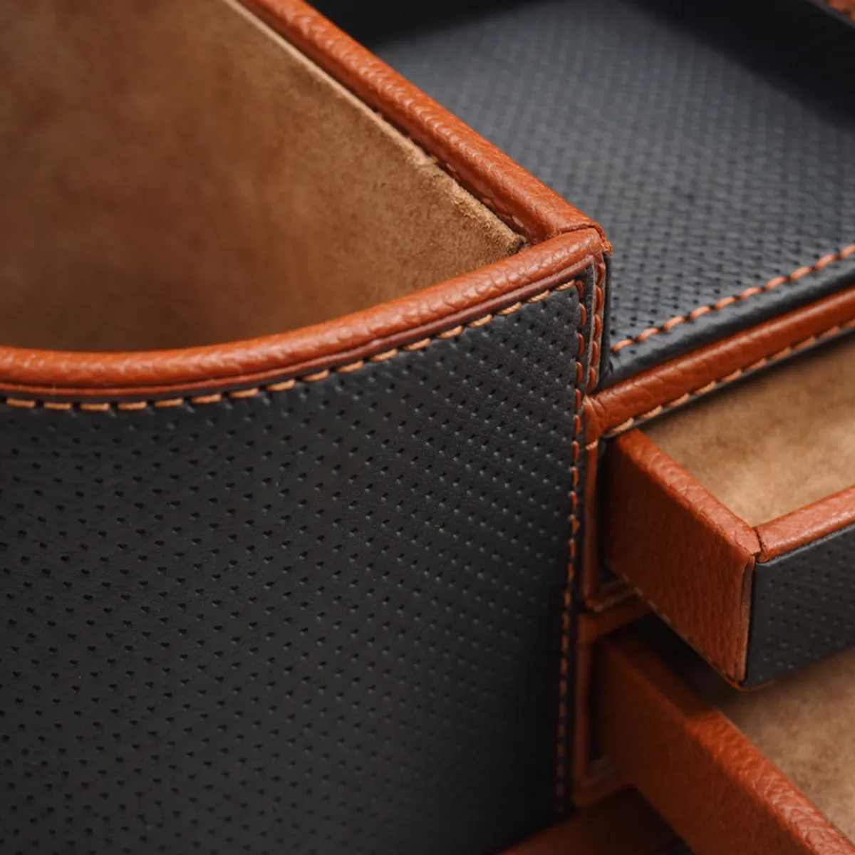 Close-up of the organiser's textured grey vegan leather surface and brown stitched trim