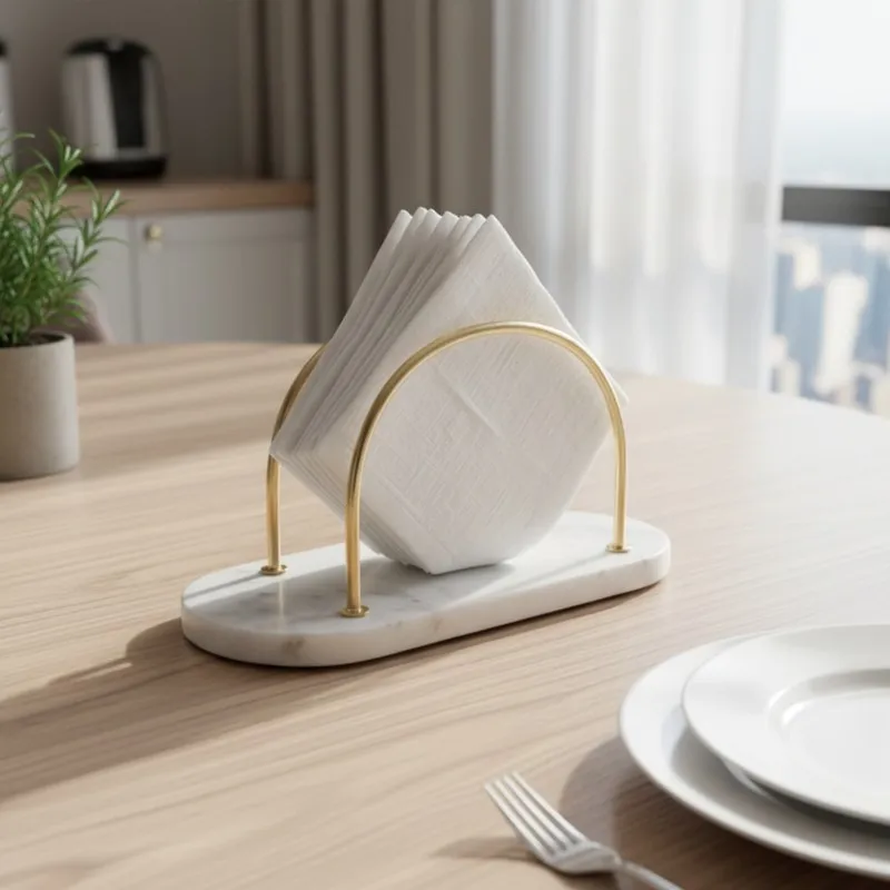 Marble and gold tissue holder styled on a light wood dining table