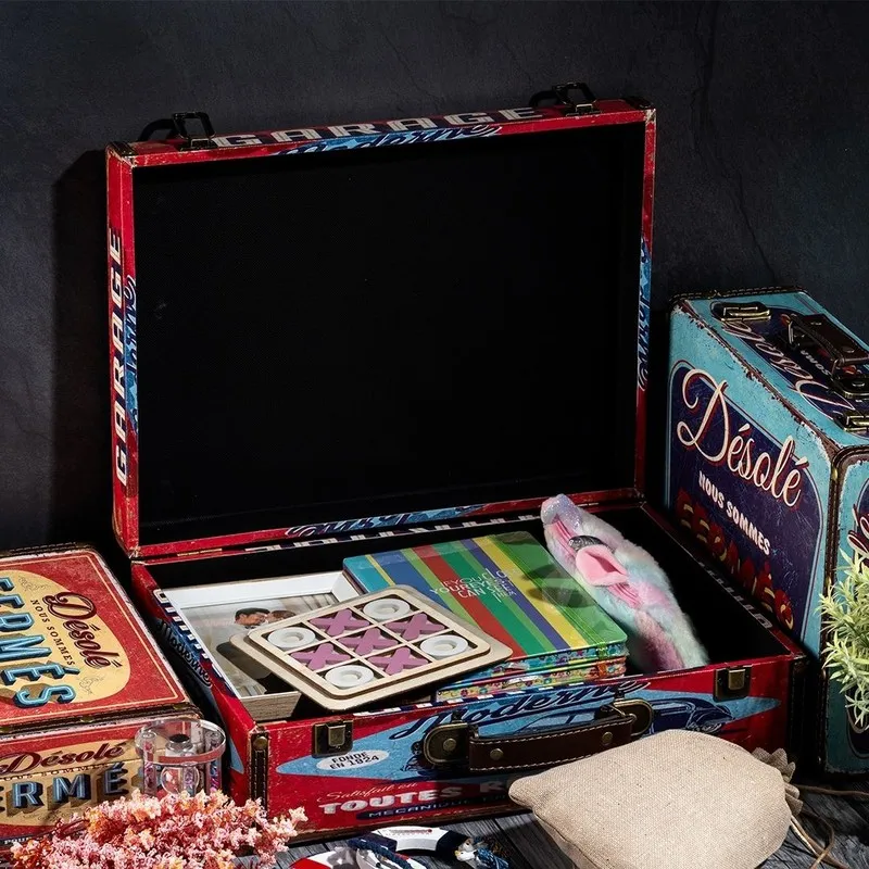 Open red storage trunk showing a spacious black-lined interior and handle
