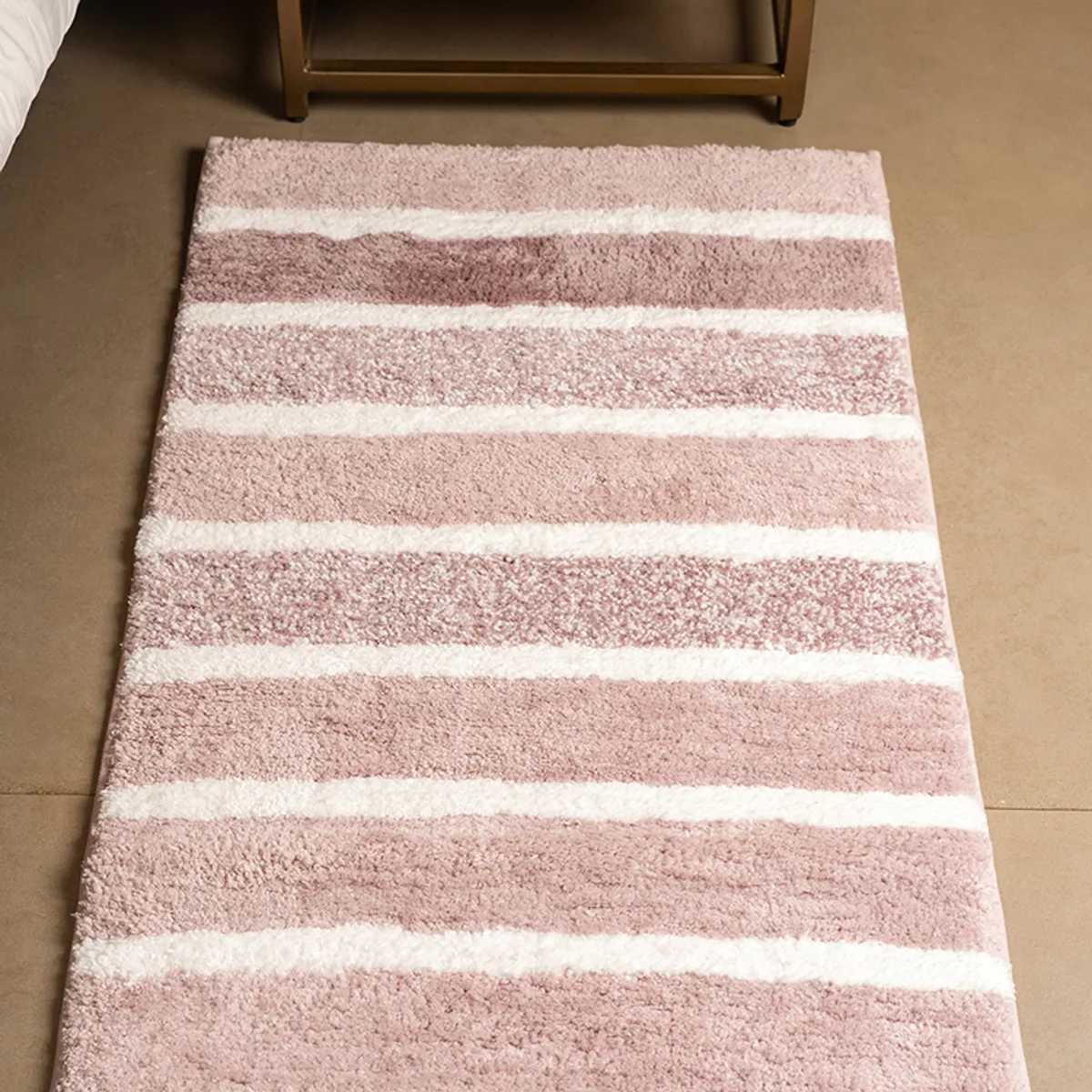 Close view of the pink and white striped plush runner
