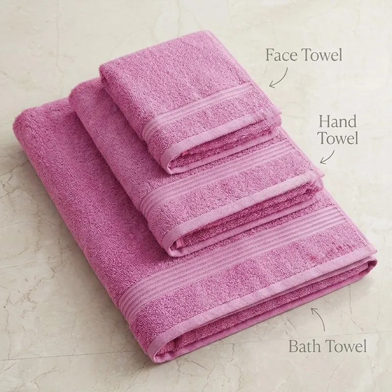 Folded pink bath, hand and face towels stacked together