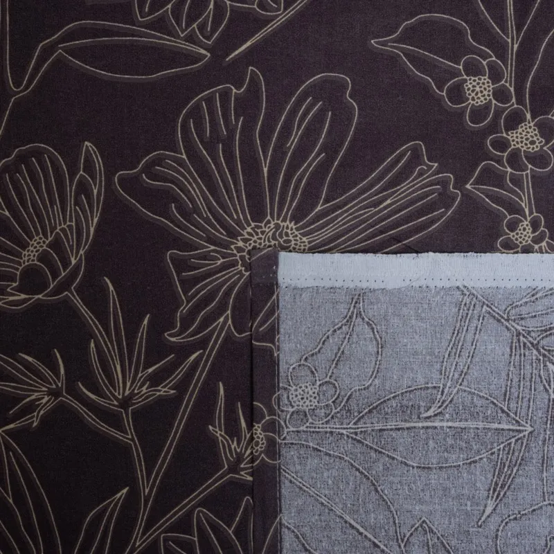 Bedsheet corner detail with floral print and underside visible