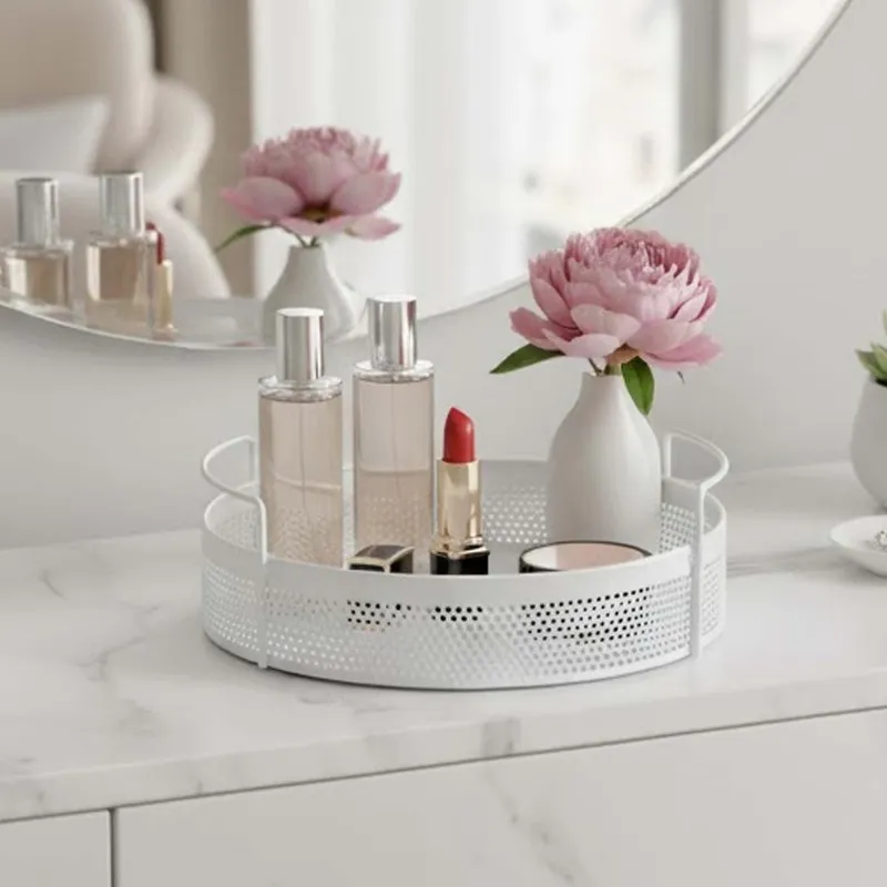 White round metal basket holding perfume, lipstick and a flower vase