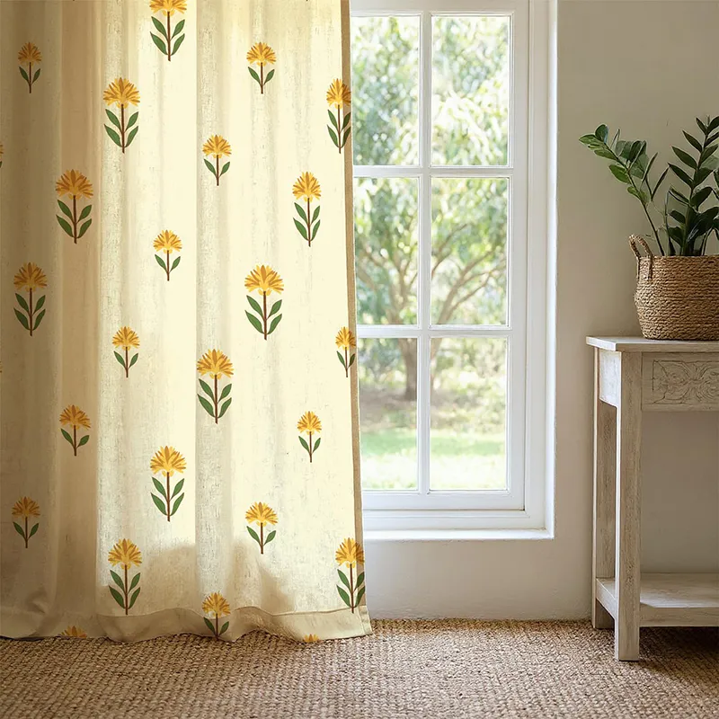 Yellow floral printed ivory curtain hanging beside a sunlit window