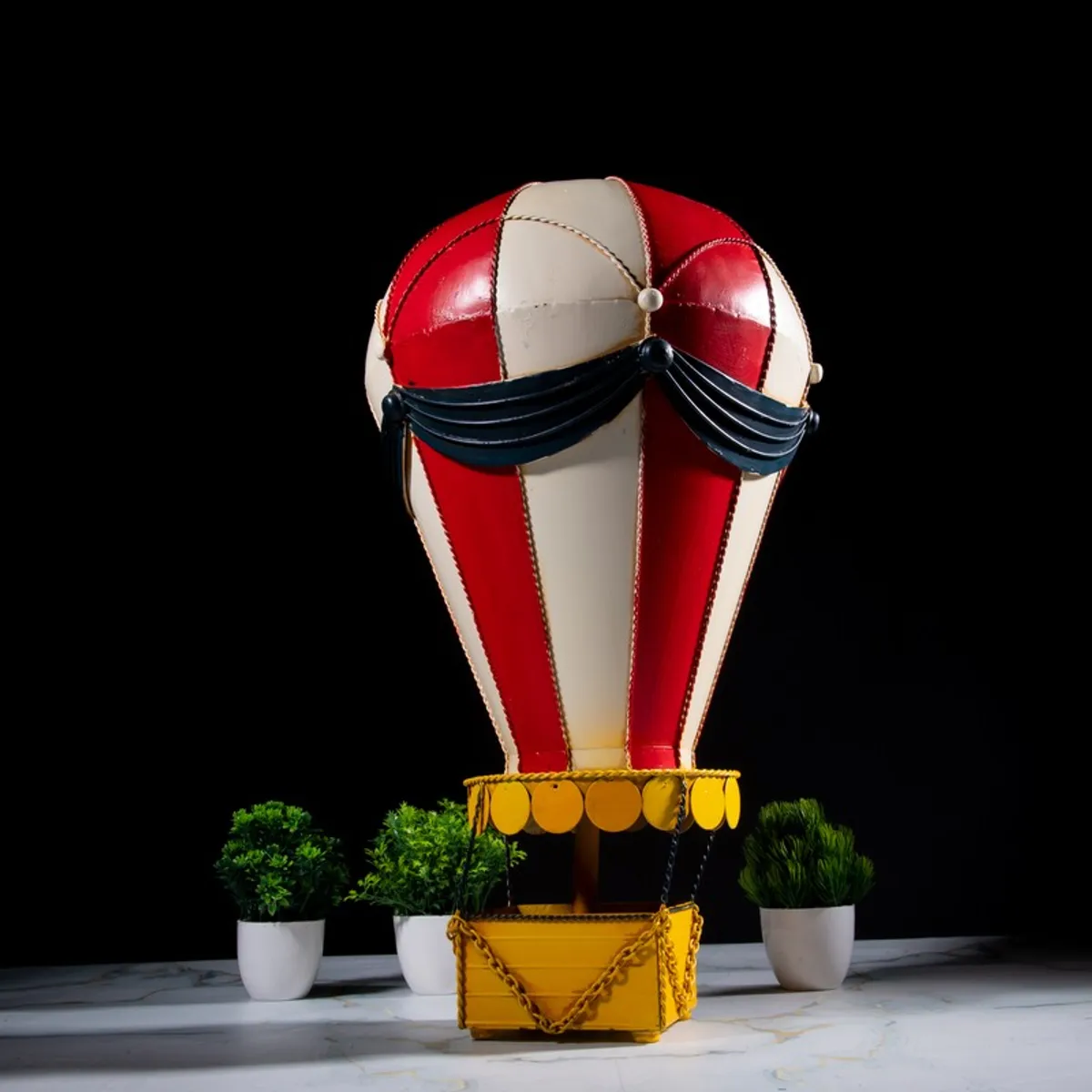Front view of hot air balloon showpiece with red, cream and yellow finish