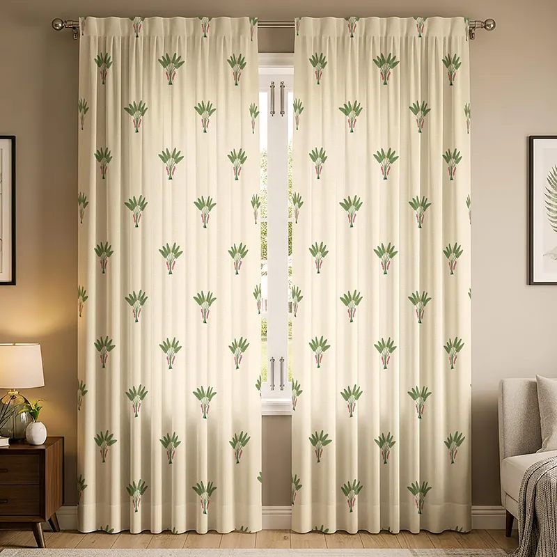 Set of printed off-white curtains with green botanical motifs on a window