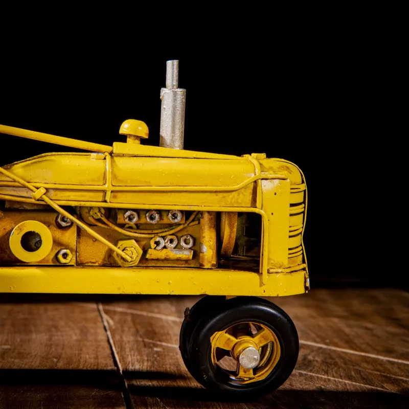 Close-up side view of yellow tractor showpiece details