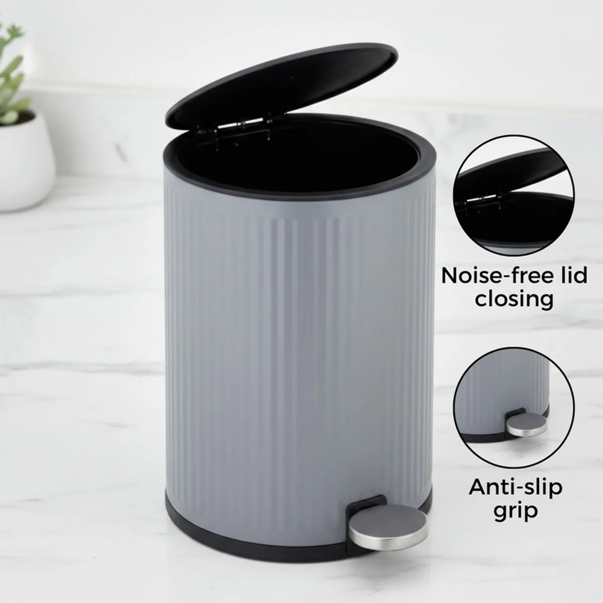 Grey cylindrical dustbin with open lid and pedal detail