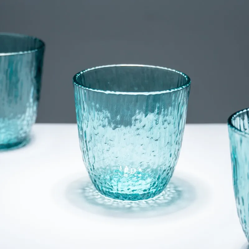 Close-up of a single blue textured drinking glass
