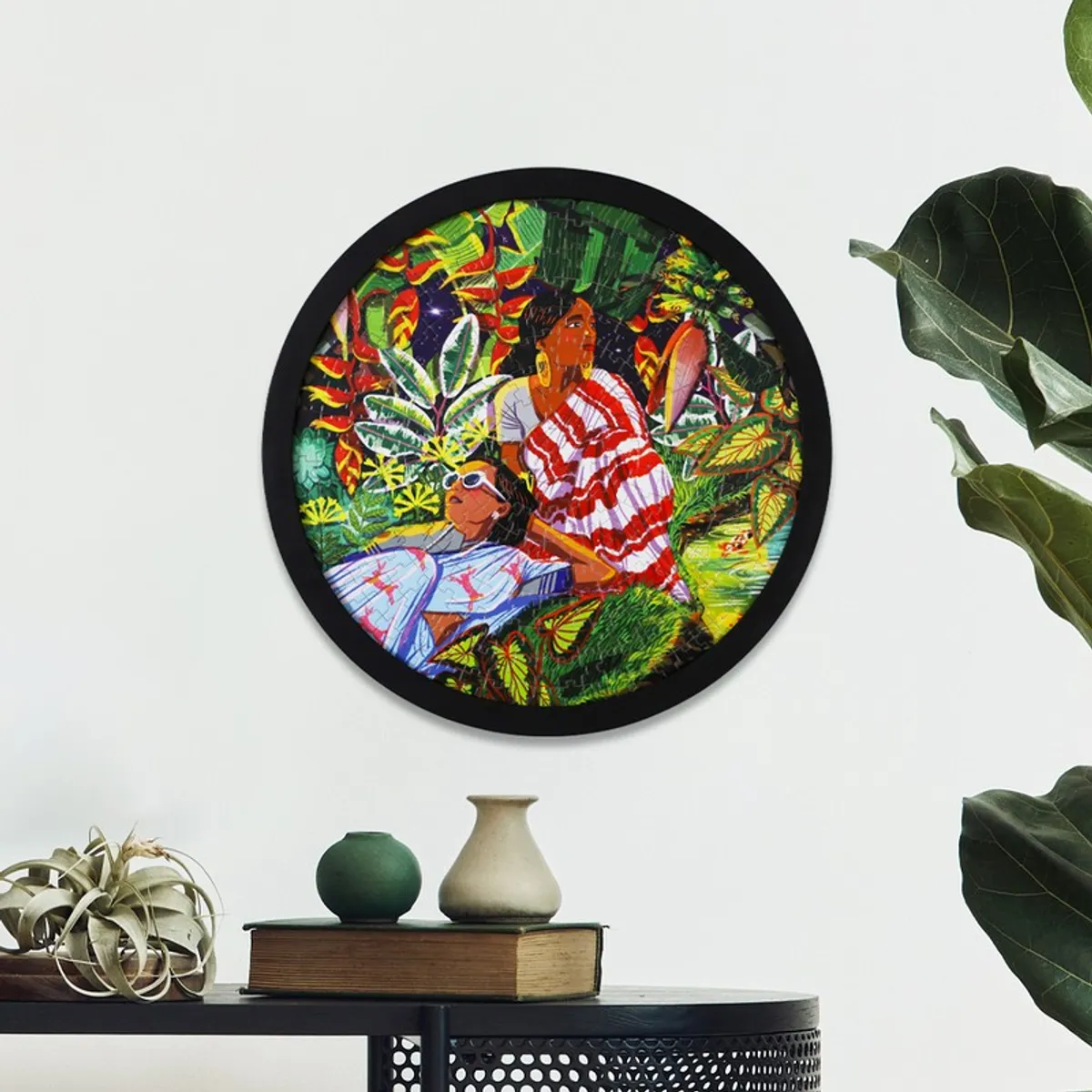 Round multicolour wall art hung on a white wall above a table
