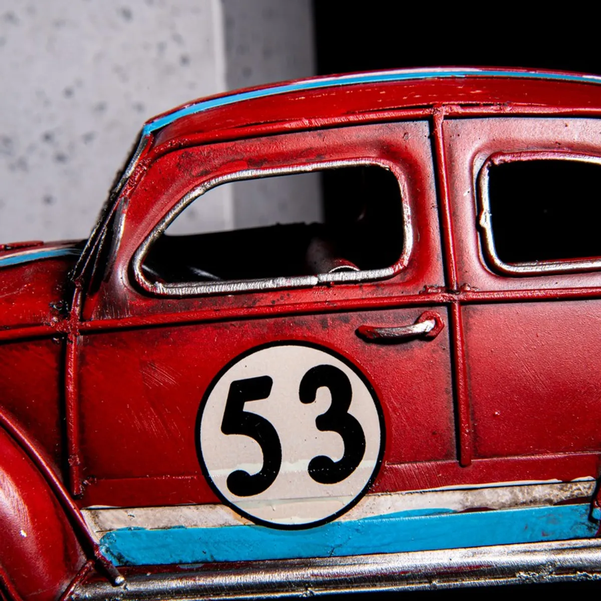 Close-up of the side door and number detail on the red car showpiece