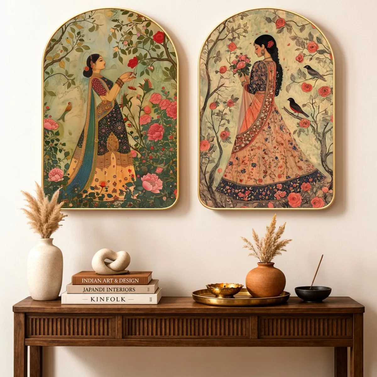 Set of two ornate wall art panels with floral and bird motifs above a console