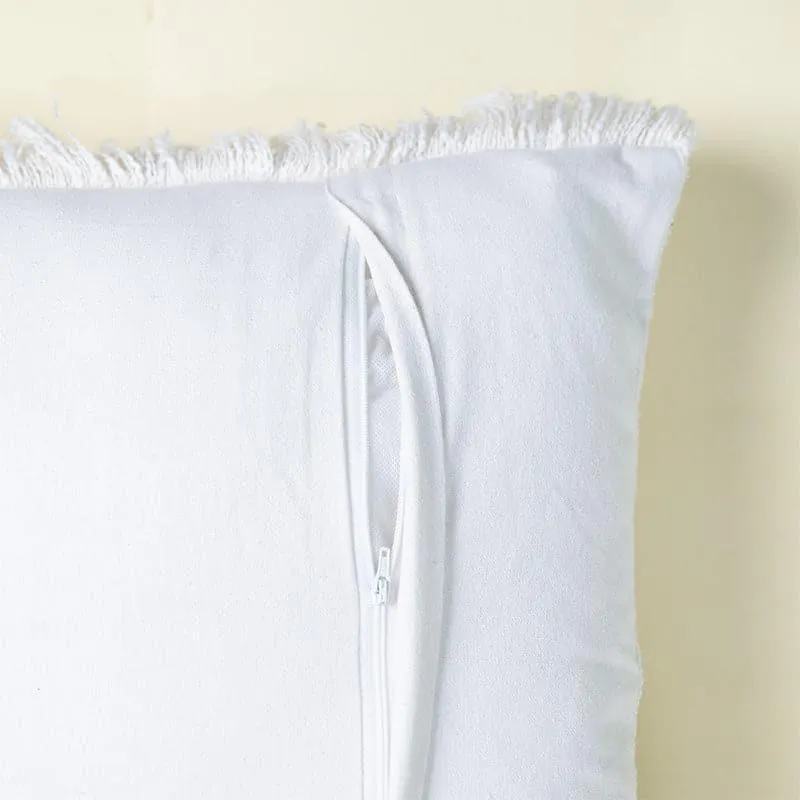 Back view of a white cushion cover showing a concealed side opening and fringed edge