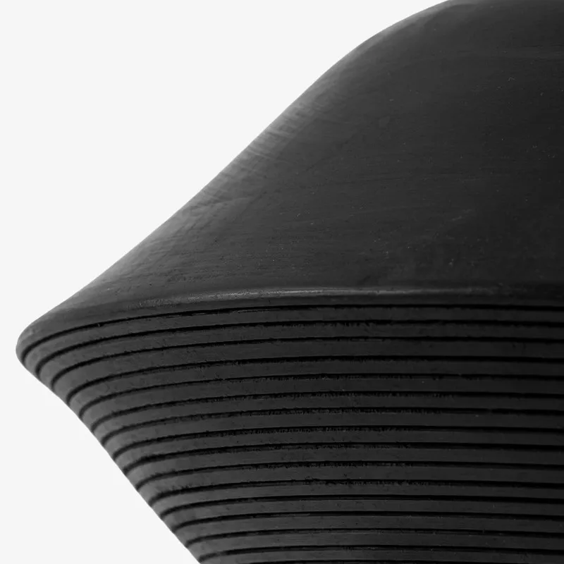 Close-up of the black lamp surface with ribbed lower detail