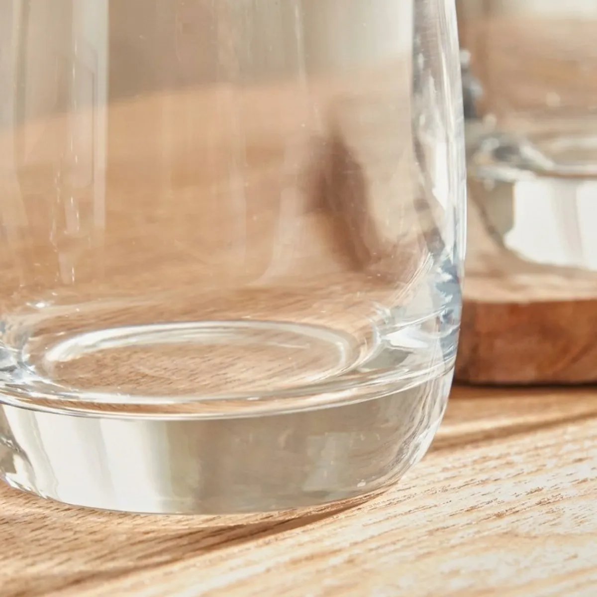 Close-up view of a transparent glass with a glossy finish and thick base