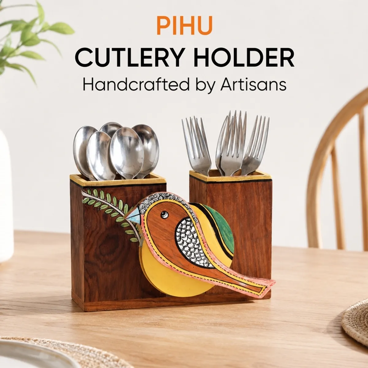Colourful sparrow cutlery holder placed on a dining table with spoons and forks.
