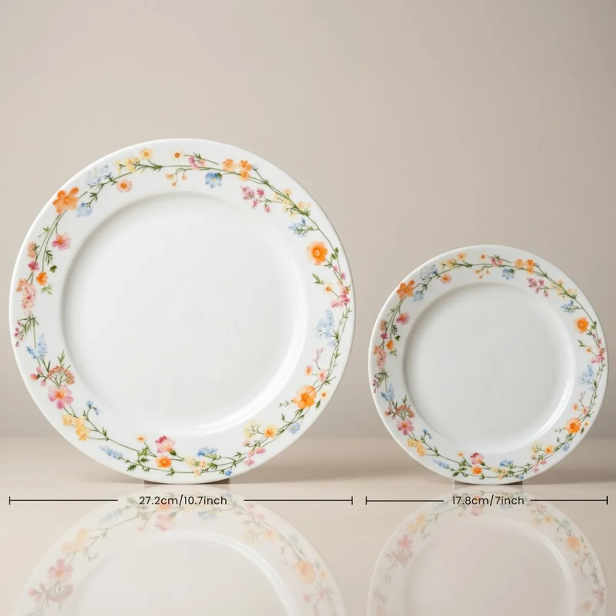 Large and small white plates with delicate multicolour floral vine borders
