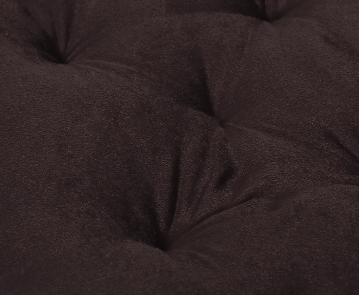 Close-up of brown velvet cushion surface with subtle gathered texture