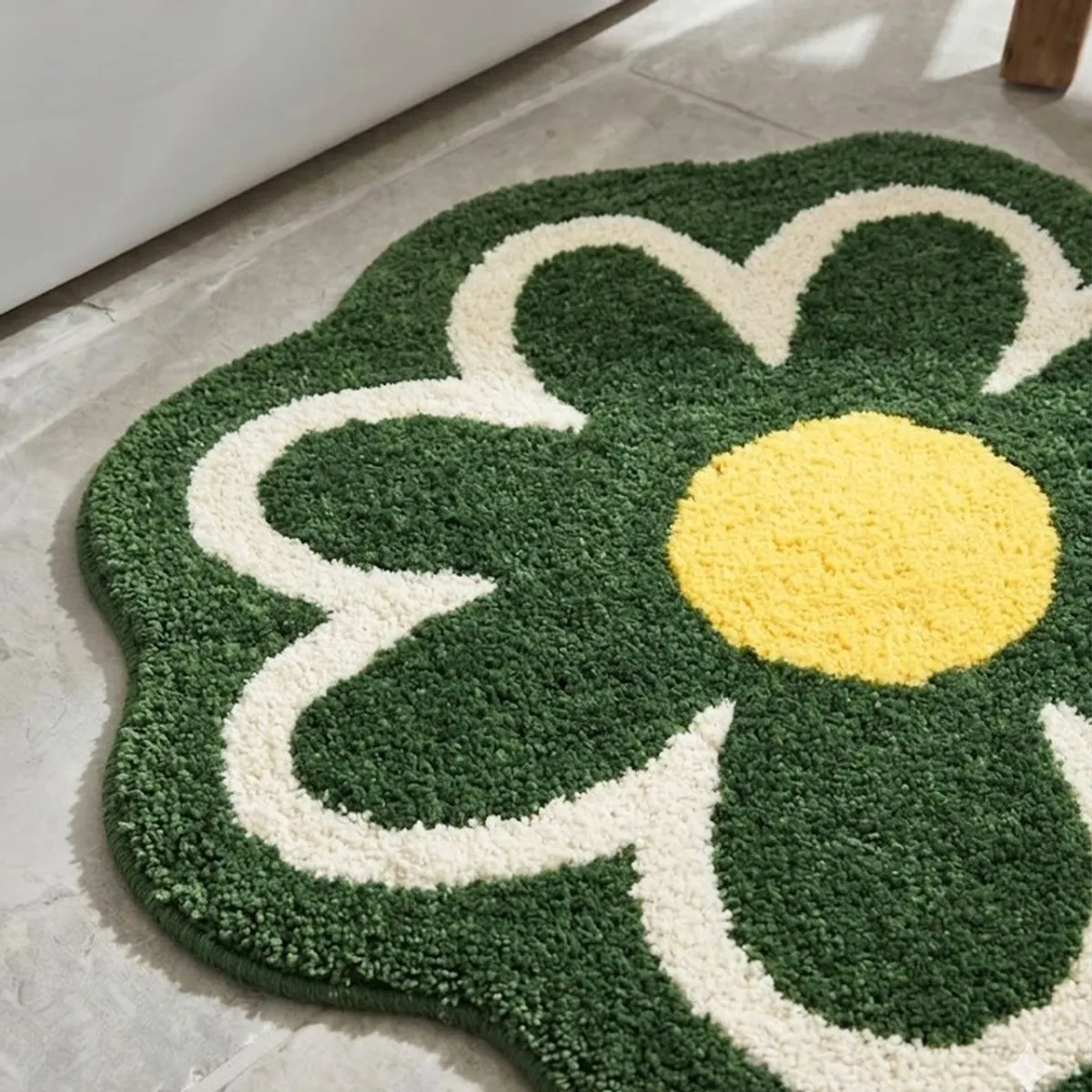Close-up of the plush green and cream floral bath mat with a yellow centre