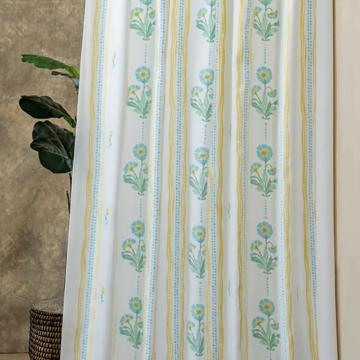 Close view of floral striped curtain with blue, yellow and green motifs