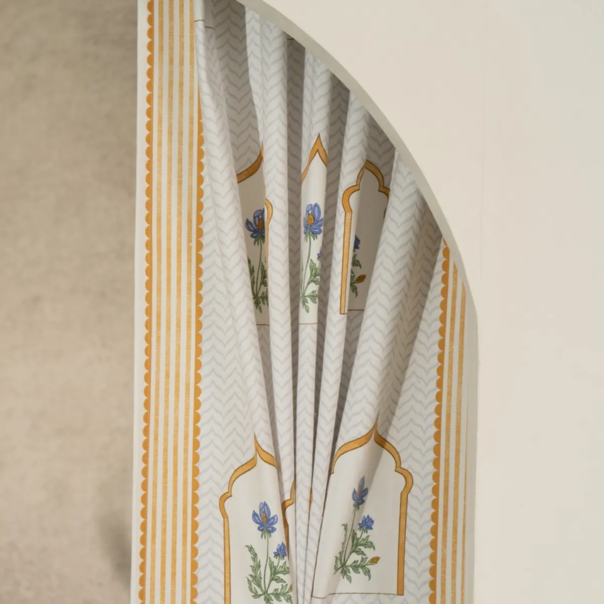Draped curtain showing floral arches and yellow striped border