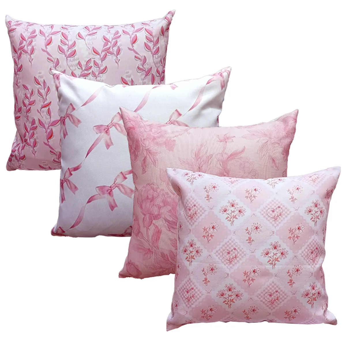 Four square pink printed cushion covers displayed against a white background